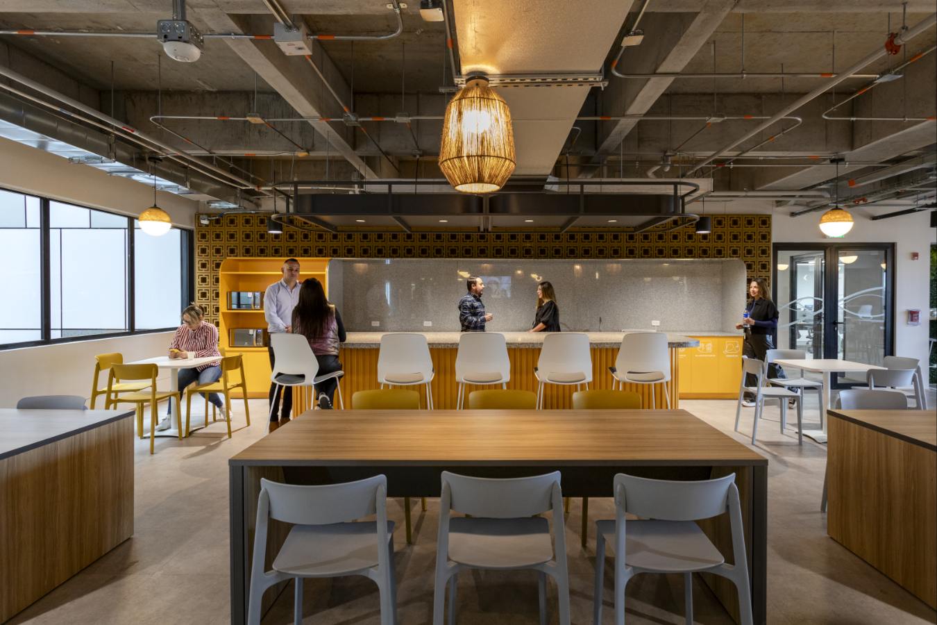 Emapta Offices - Office pantry area with high-top collaboration tables and yellow tiling - Contract Workplaces.jpg